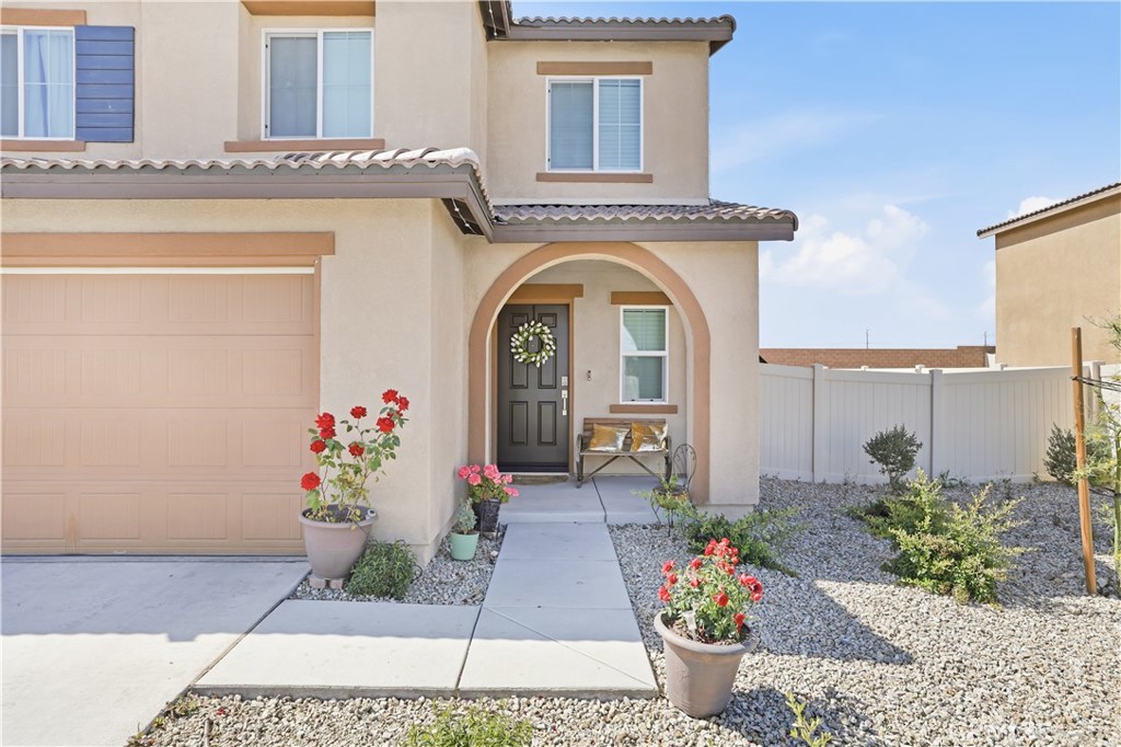 10143 Colten Ridge Adelanto, CA 92301 - Photo 4 of 36 a front view of a house with flower pots
