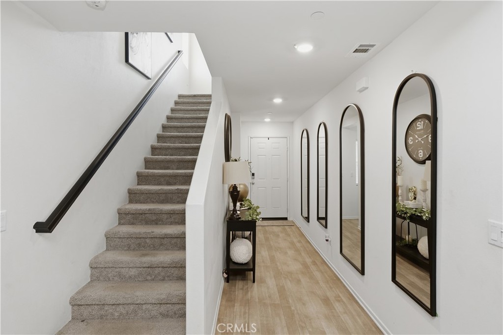 10143 Colten Ridge Adelanto, CA 92301 - Photo 7 of 36 a view of a hallway with wooden floor and staircase