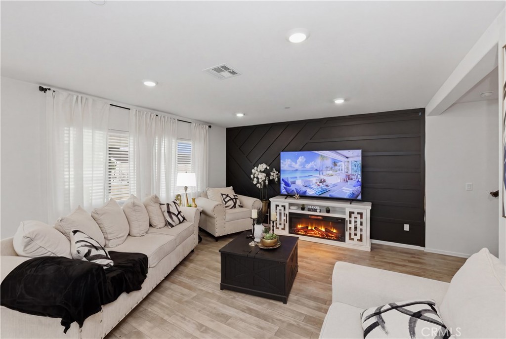 10143 Colten Ridge Adelanto, CA 92301 - Photo 8 of 36 a living room with furniture and a flat screen tv