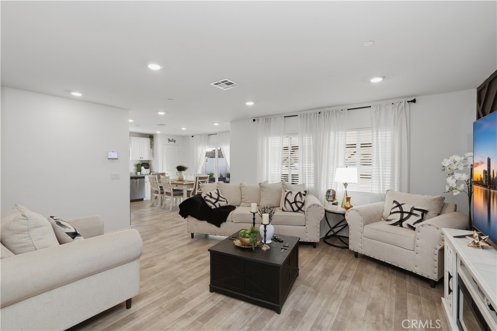 10143 Colten Ridge Adelanto, CA 92301 - Photo 10 of 36 a living room with furniture and a couch