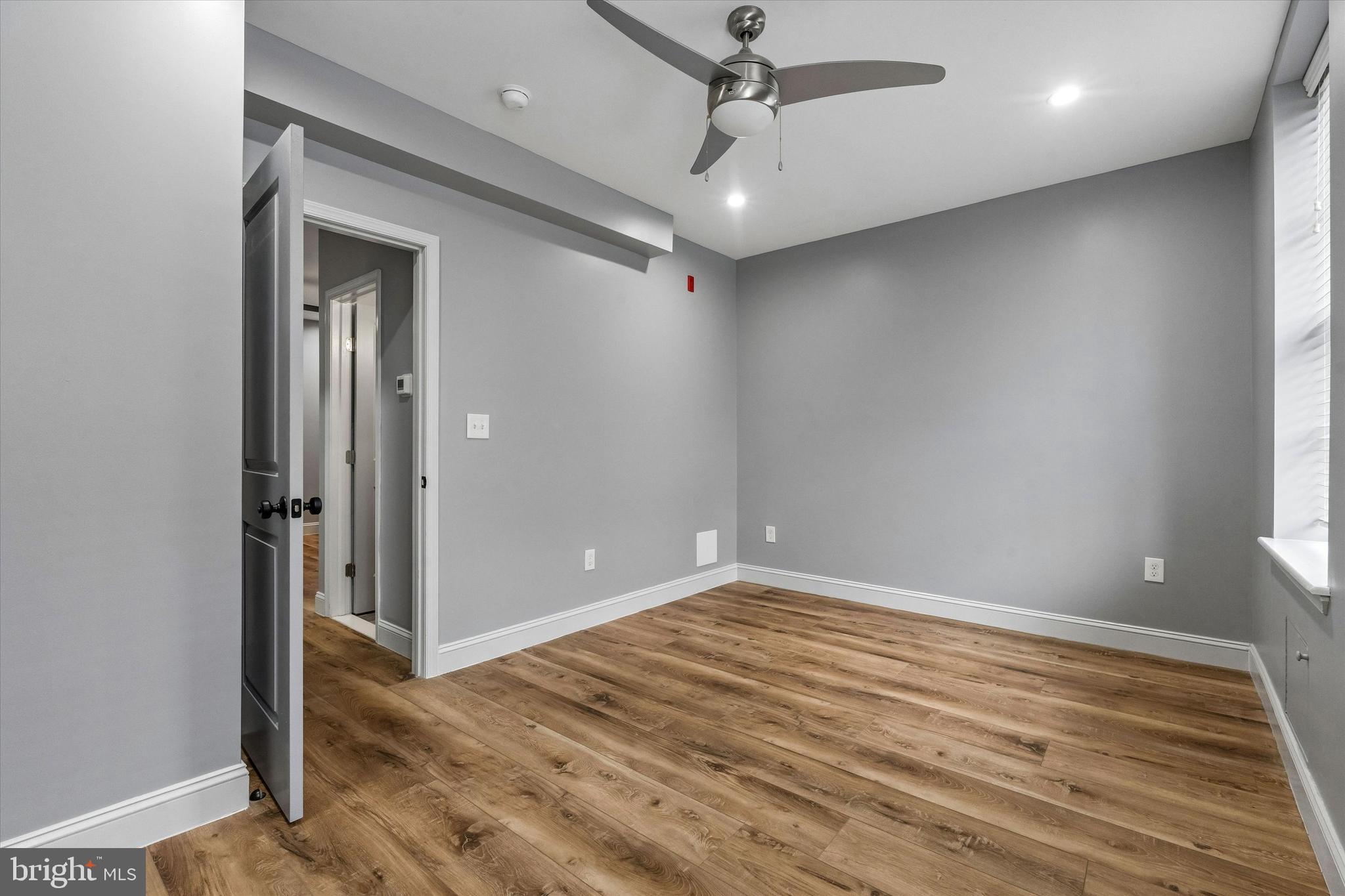 418 South 15th Street, Unit 2F Philadelphia, PA 19146 - Photo 12 of 16 a view of an empty room with wooden floor and a window