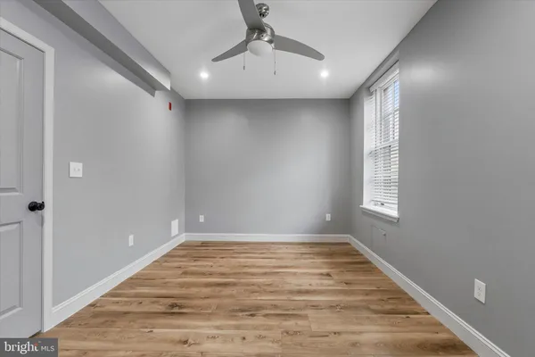 a view of a livingroom with wooden floor and a window