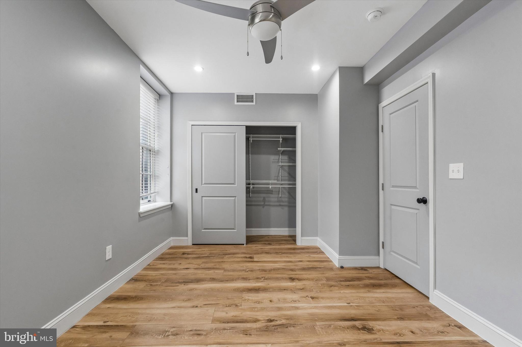 418 South 15th Street, Unit 2F Philadelphia, PA 19146 - Photo 14 of 16 a view of a livingroom with wooden floor and a window