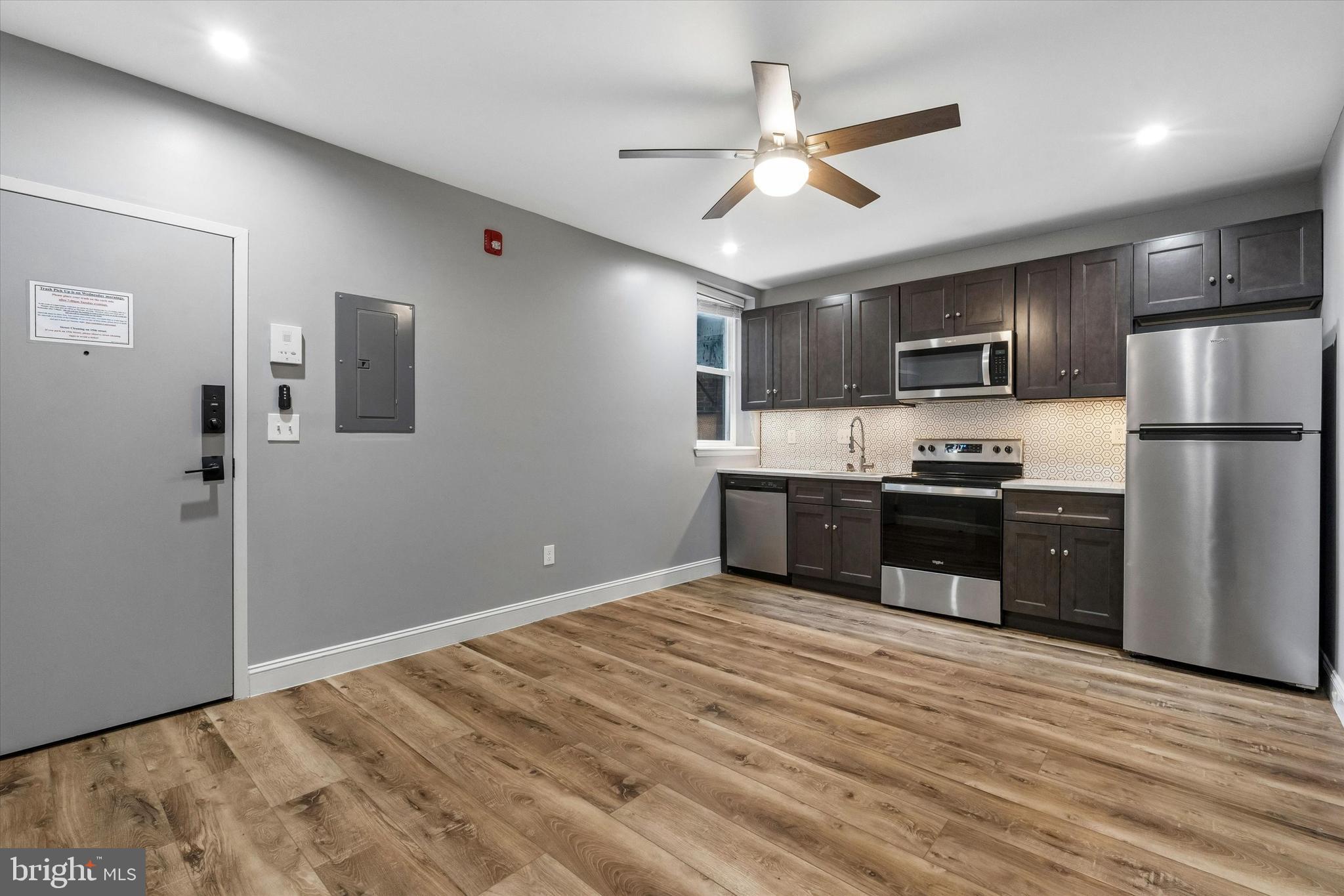 418 South 15th Street, Unit 2F Philadelphia, PA 19146 - Photo 2 of 16 a kitchen with stainless steel appliances kitchen island a refrigerator sink and cabinets