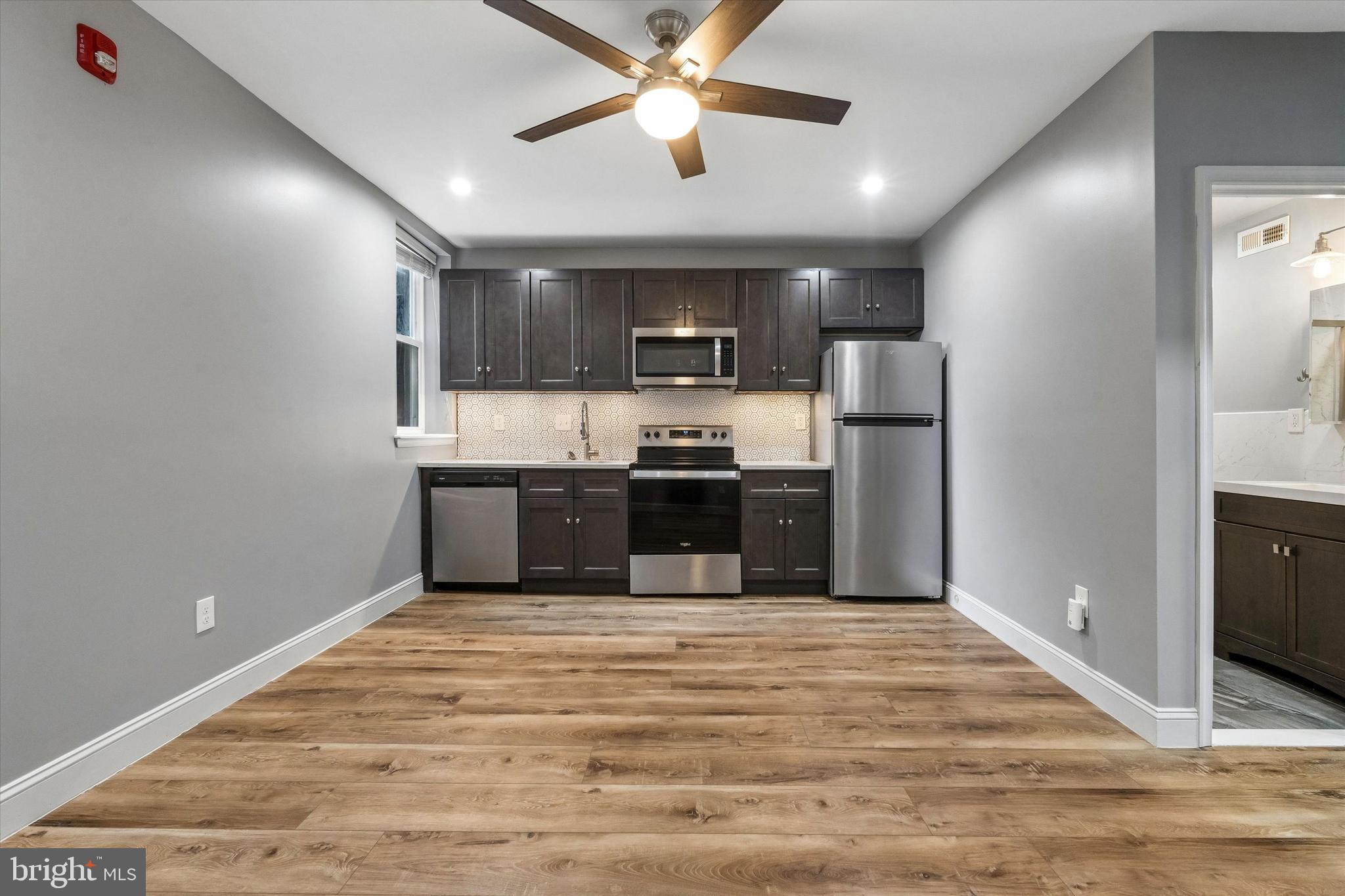 418 South 15th Street, Unit 2F Philadelphia, PA 19146 - Photo 3 of 16 a kitchen with stainless steel appliances a refrigerator and a stove
