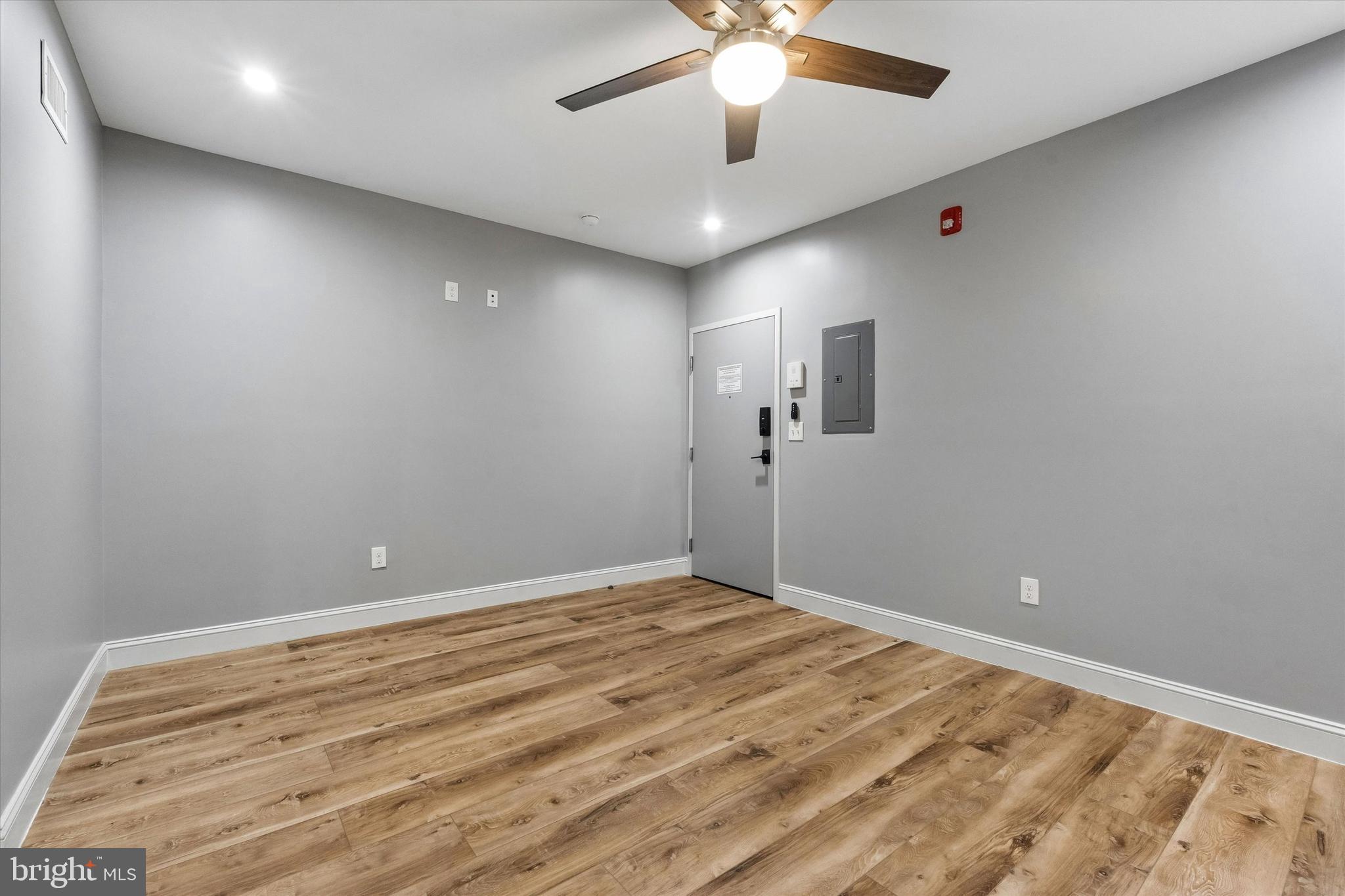 418 South 15th Street, Unit 2F Philadelphia, PA 19146 - Photo 5 of 16 an empty room with a chandelier fan and windows