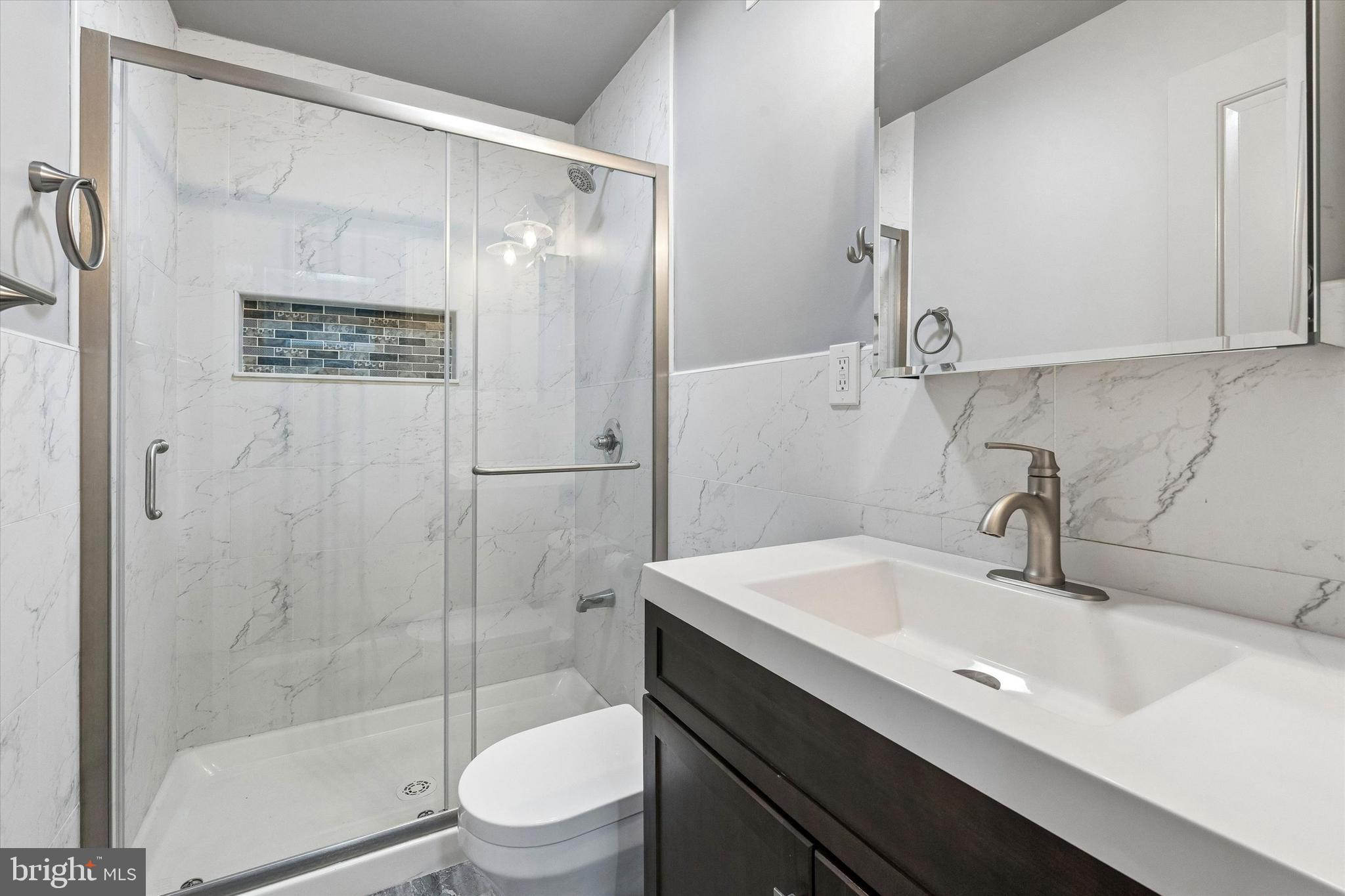 418 South 15th Street, Unit 2F Philadelphia, PA 19146 - Photo 7 of 16 a bathroom with a sink a toilet and shower