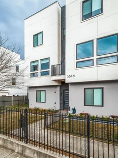 a front view of a house with a iron gate