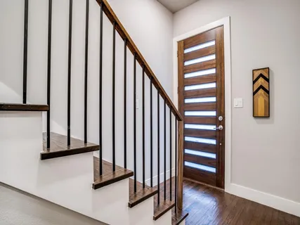a view of staircase with wooden floor and chair