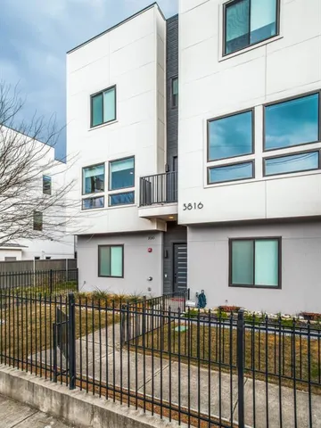 a front view of a house with a iron gate