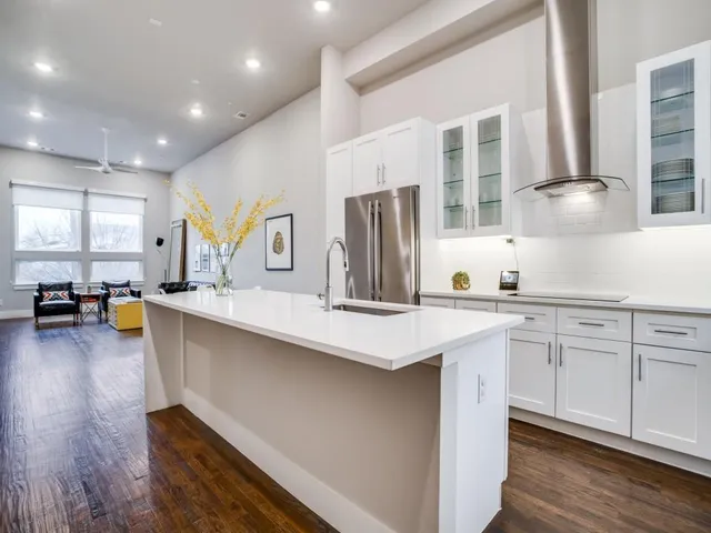 a kitchen with counter top space and living room view