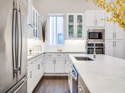 a kitchen with granite countertop a stove and a sink