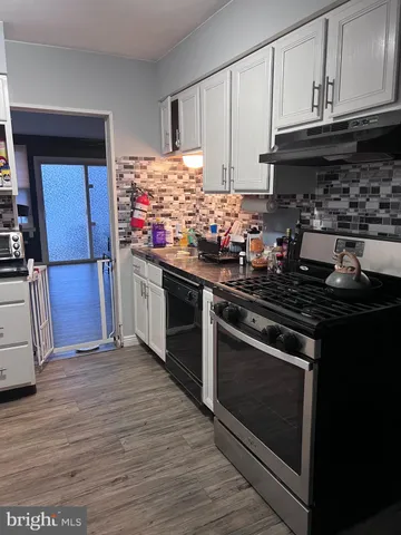 a kitchen with granite countertop wooden cabinets and stainless steel appliances