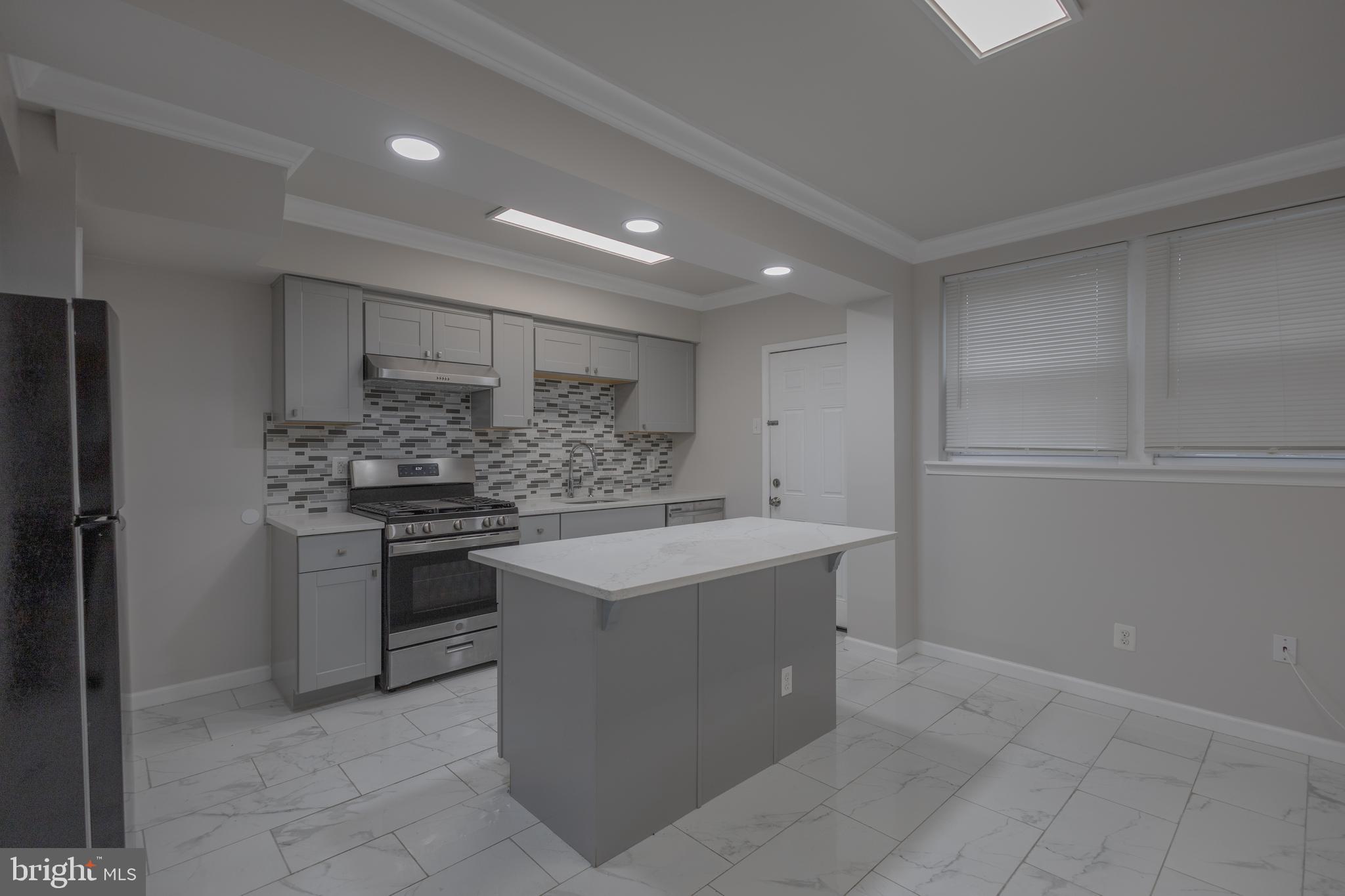 2636 South 73rd Street Philadelphia, PA 19153 - Photo 1 of 9 a kitchen with a sink and stainless steel appliances