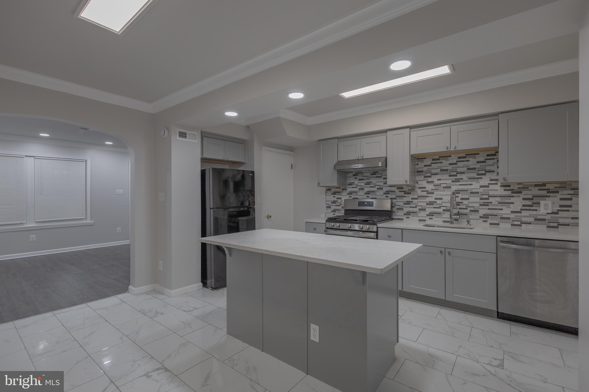 2636 South 73rd Street Philadelphia, PA 19153 - Photo 2 of 9 a kitchen with stainless steel appliances granite countertop a sink and cabinets