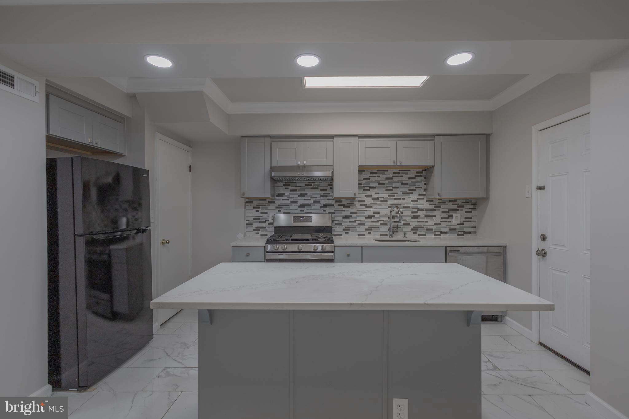 2636 South 73rd Street Philadelphia, PA 19153 - Photo 3 of 9 a kitchen with a sink and refrigerator
