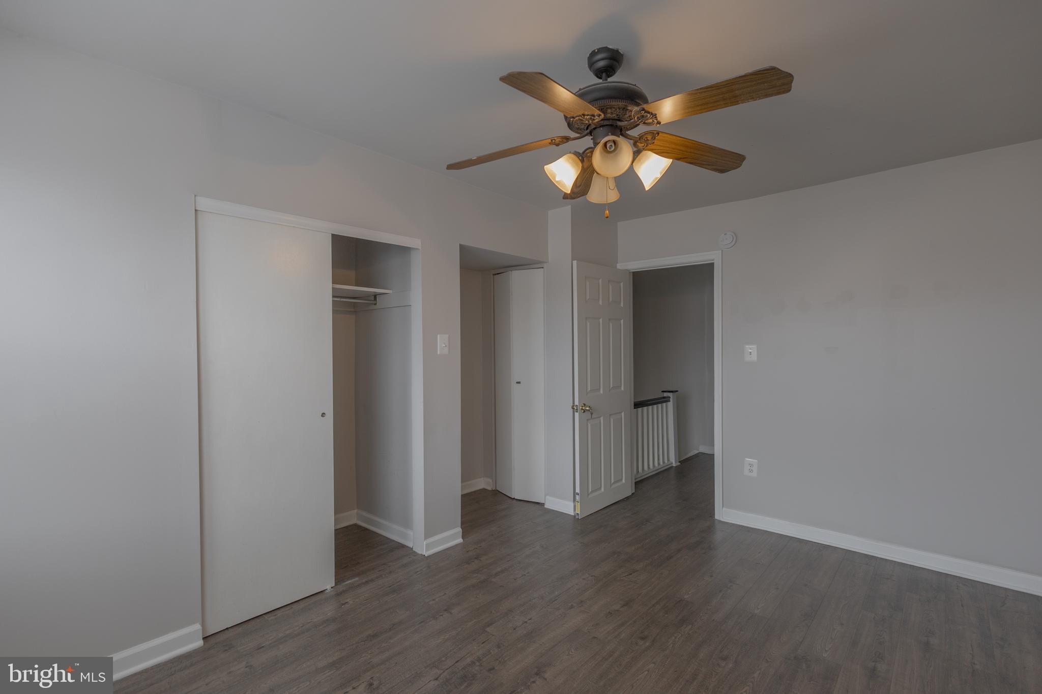 2636 South 73rd Street Philadelphia, PA 19153 - Photo 4 of 9 a view of an empty room with wooden floor and a ceiling fan