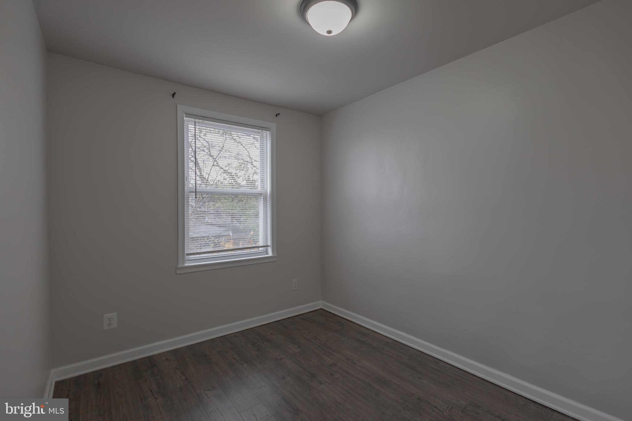 2636 South 73rd Street Philadelphia, PA 19153 - Photo 8 of 9 an empty room with wooden floor and windows