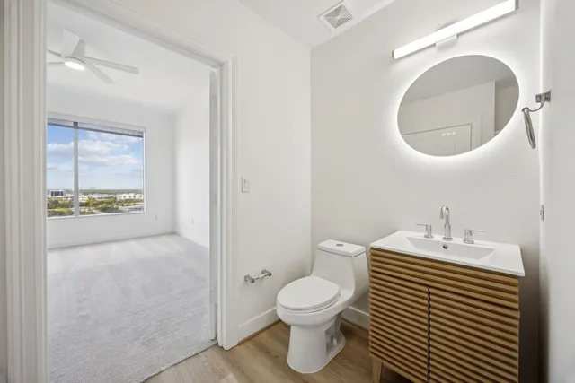a bathroom with a sink toilet and a mirror