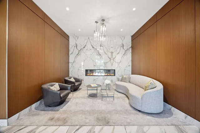 a living room with furniture and a chandelier