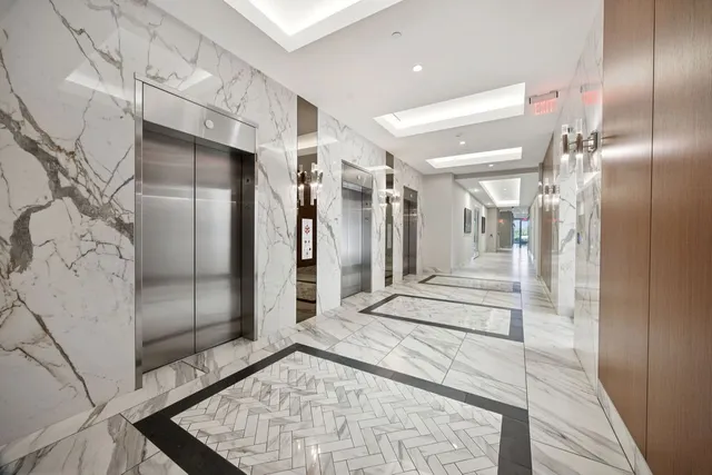a bathroom with a glass shower door and a sink