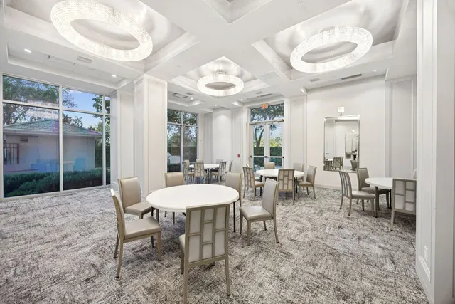 a view of a dining room with furniture and a chandelier