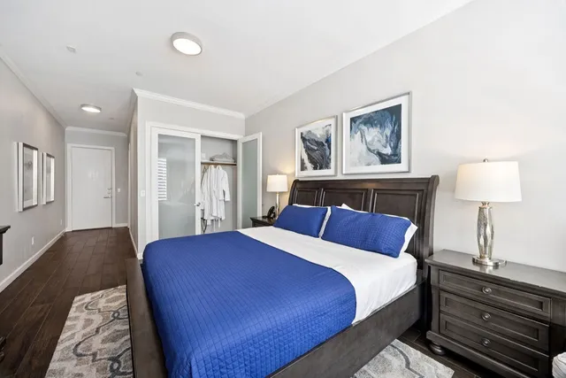 a bedroom with a large bed and a lamp on table