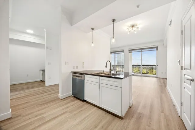 a kitchen with granite countertop a stove and a sink