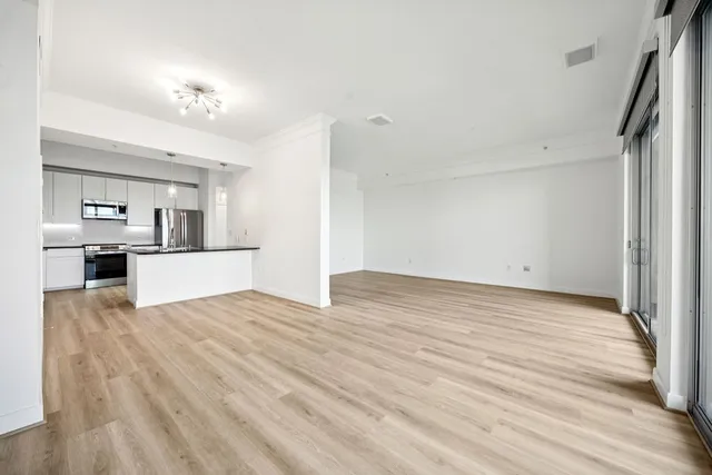 a view of a kitchen with wooden floor and a kitchen