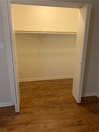 a view of a room with wooden floor and a window