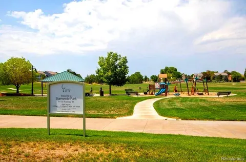 a view of a park with swings and slides