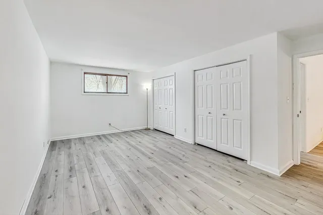 a view of a room with wooden floor