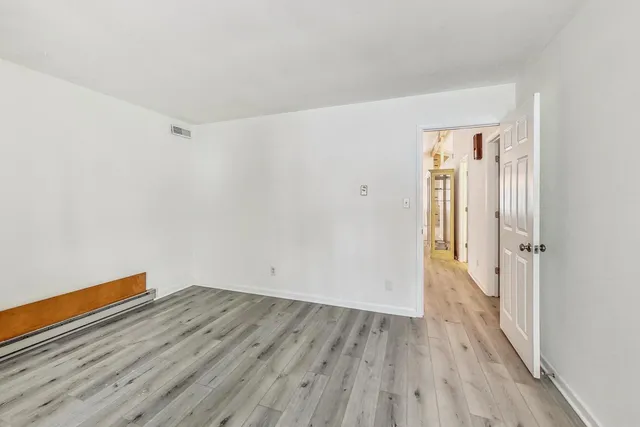 a view of a room with wooden floor