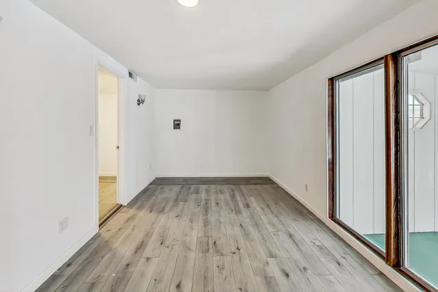 a view of a room with wooden floor