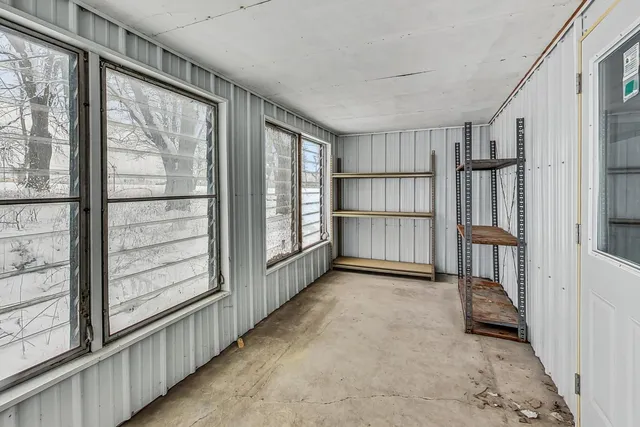 a view of empty room with wooden floor and windows