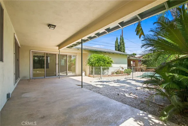 a swimming pool with outdoor seating yard and barbeque oven