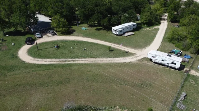 a view of a dry yard with wooden fence