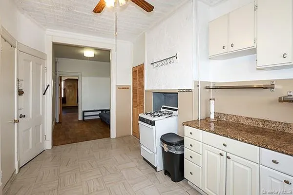 a view of hallway with a large window and wooden floor