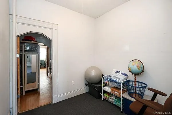 a view of an empty room with a fireplace and a window