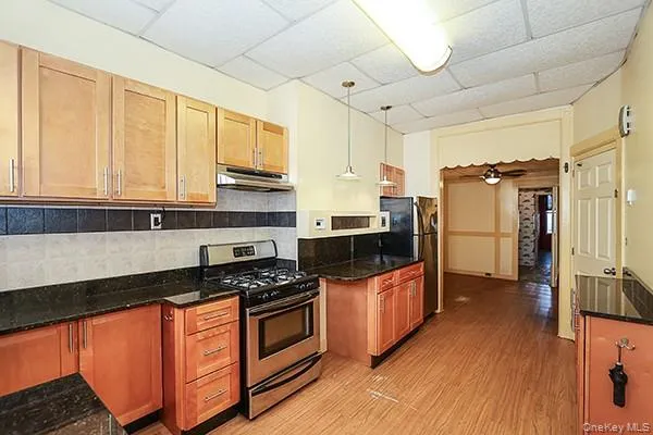 a kitchen with stainless steel appliances granite countertop a stove a sink and a refrigerator