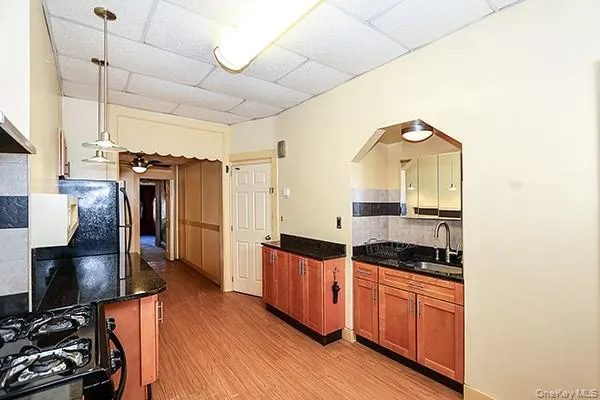 a kitchen with stainless steel appliances granite countertop a stove and a refrigerator