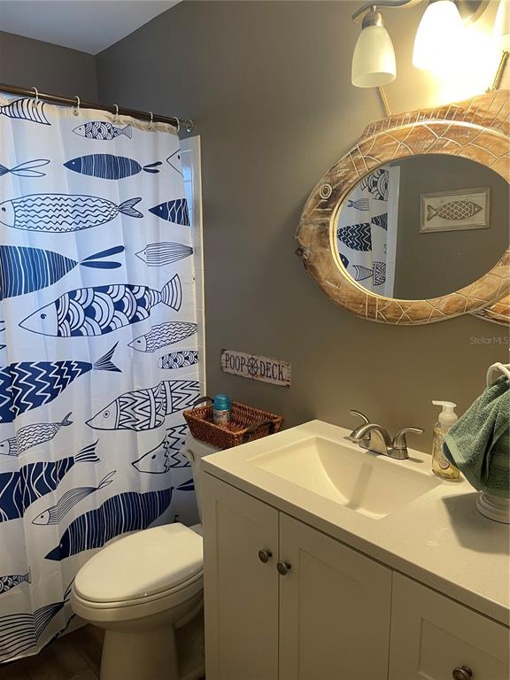 14531 Walsingham Road, Unit 203 Largo, FL 33774 - Photo 15 of 24 a bathroom with a sink and toilet