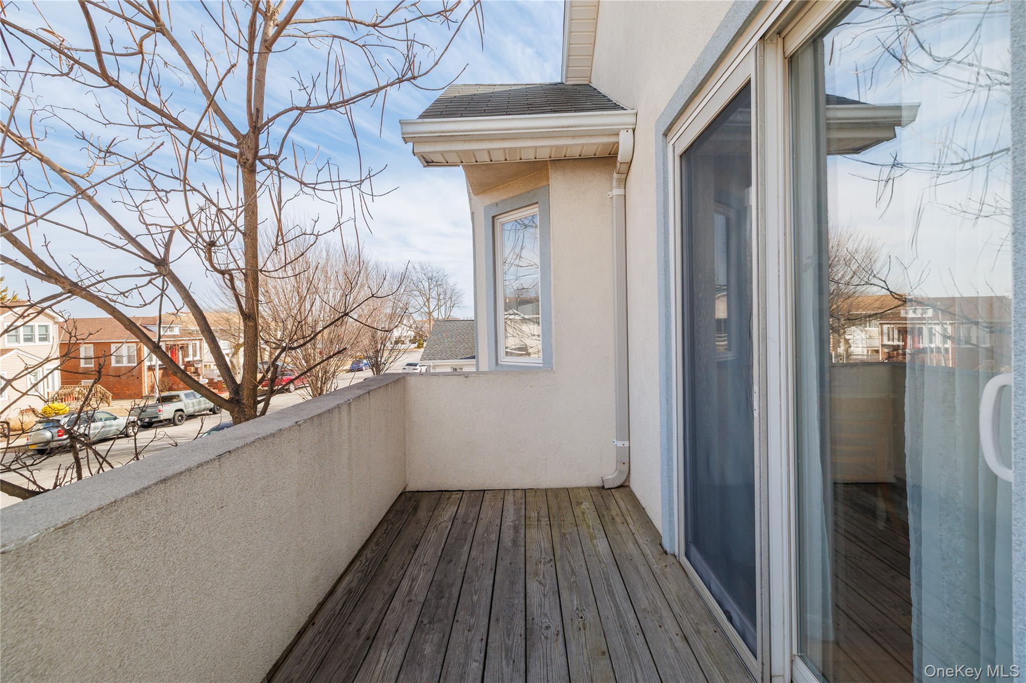 458 East Pine Street Long Beach, NY 11561 - Photo 15 of 26 a view of a balcony with wooden floor and fence
