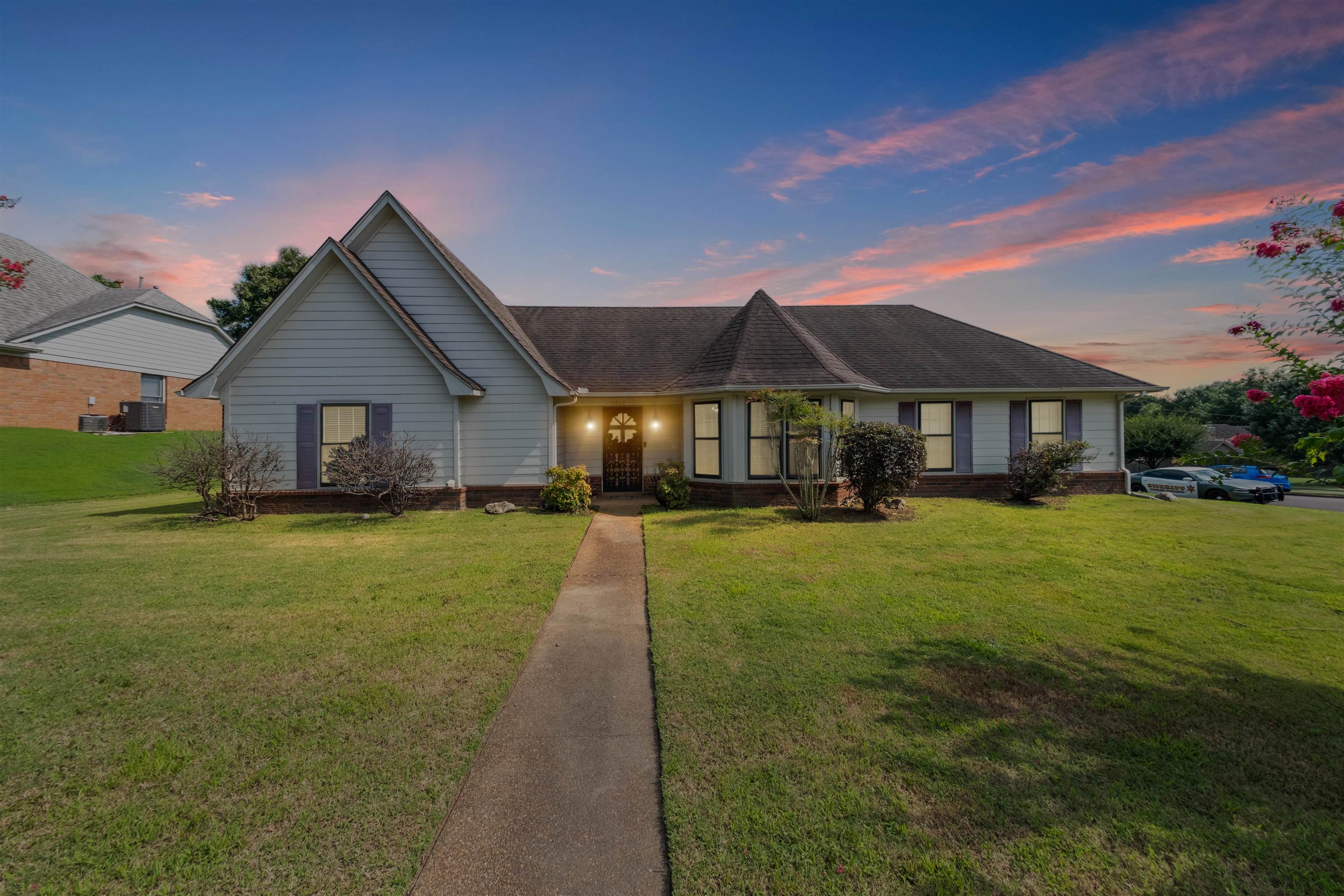 8645 Bazemore Road Memphis, TN 38018 - Photo 1 of 28 View of front of home featuring a yard and a shingled roof