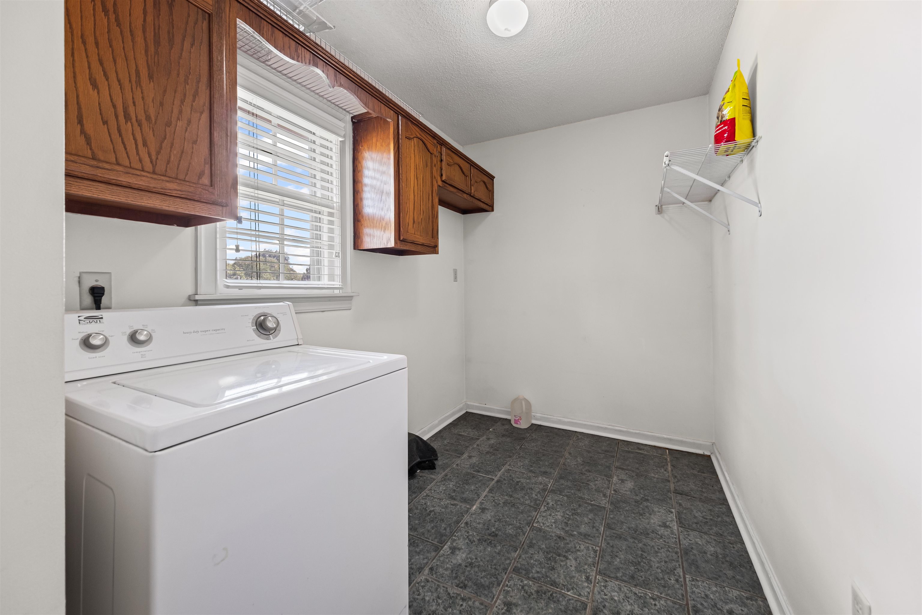 8645 Bazemore Road Memphis, TN 38018 - Photo 12 of 28 Laundry room with cabinet space, washer / dryer, and a textured ceiling