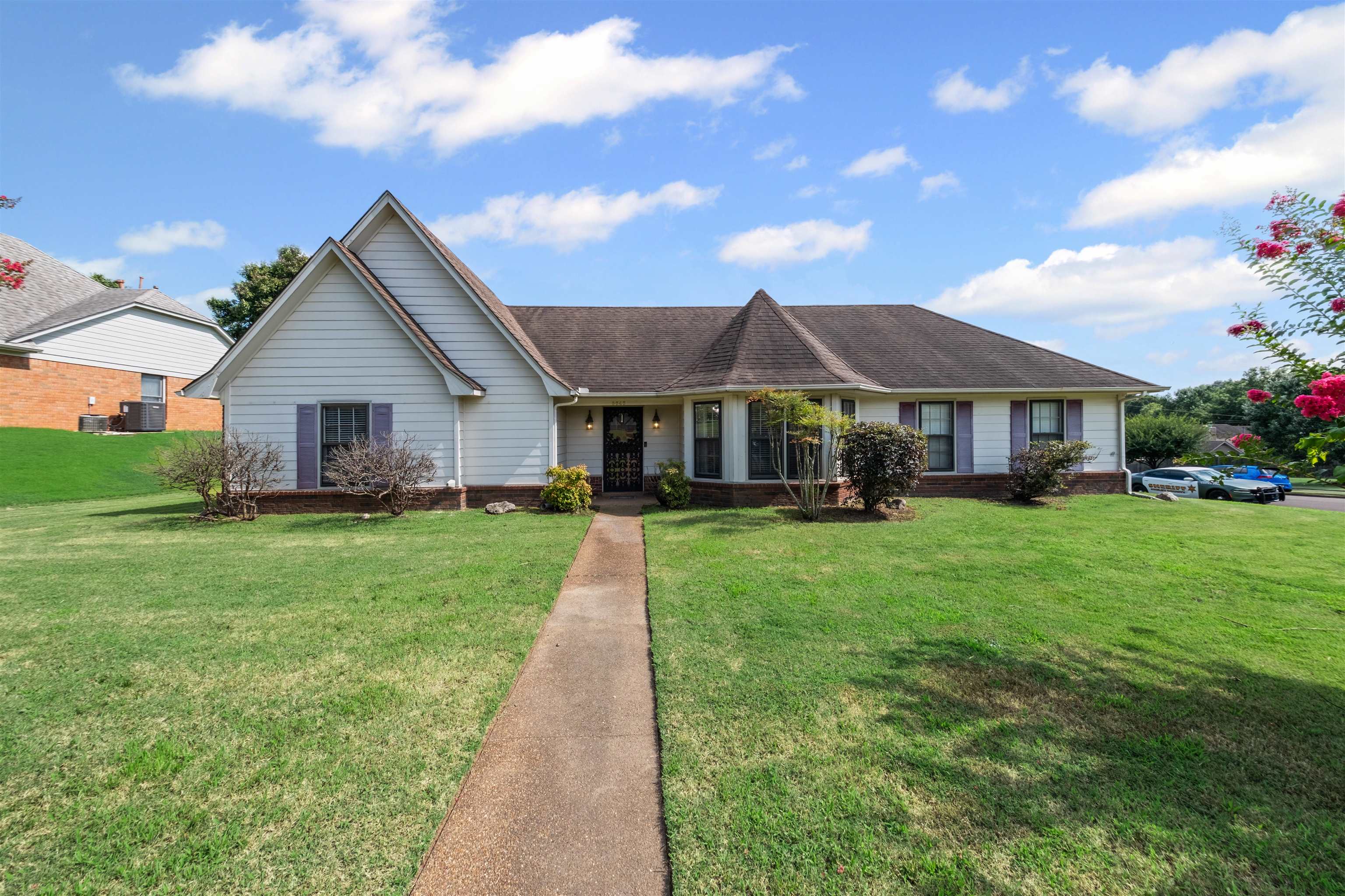 8645 Bazemore Road Memphis, TN 38018 - Photo 2 of 28 Single story home featuring a front lawn, brick siding, covered porch, and roof with shingles