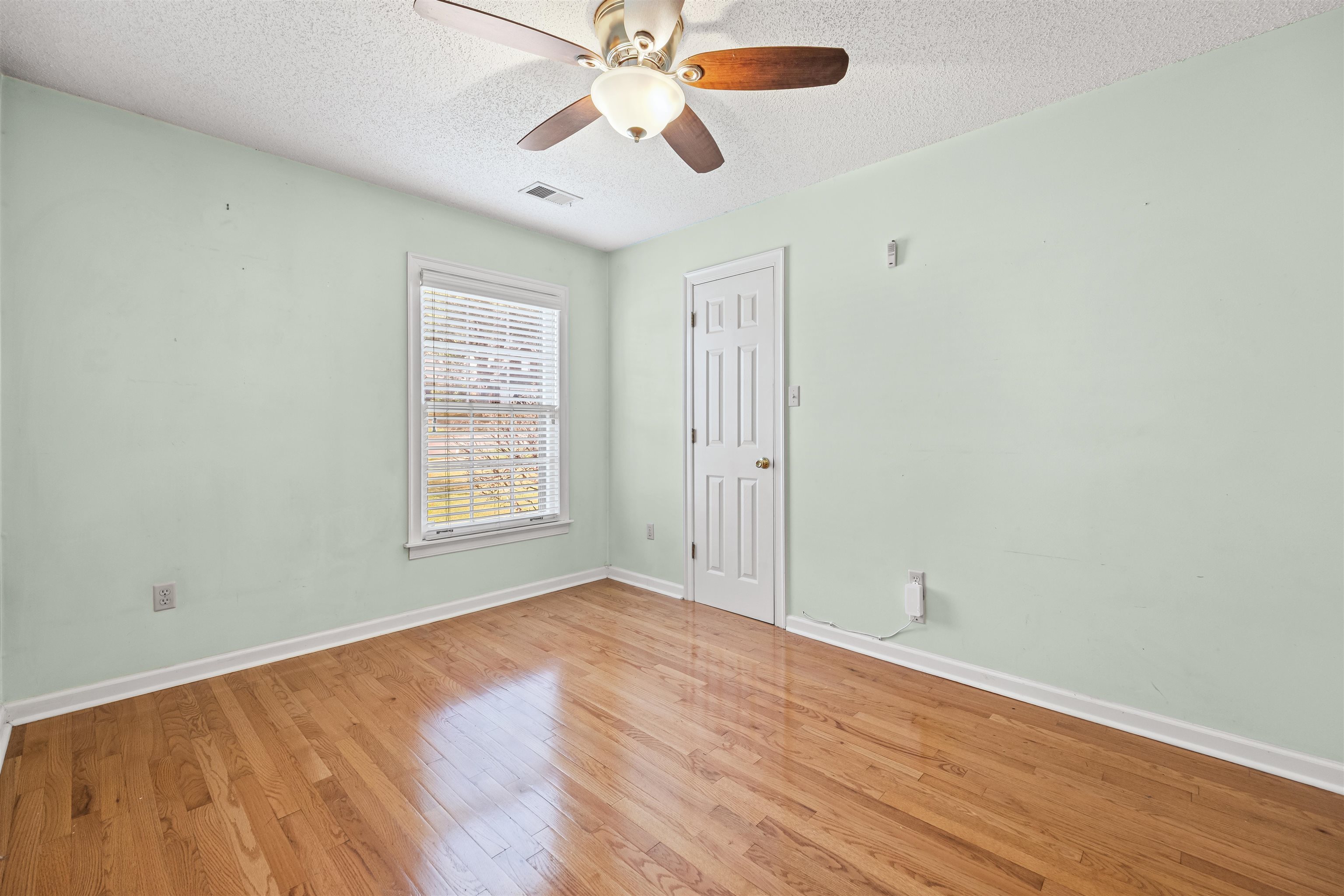 8645 Bazemore Road Memphis, TN 38018 - Photo 21 of 28 Spare room with a textured ceiling, light wood-style floors, and ceiling fan