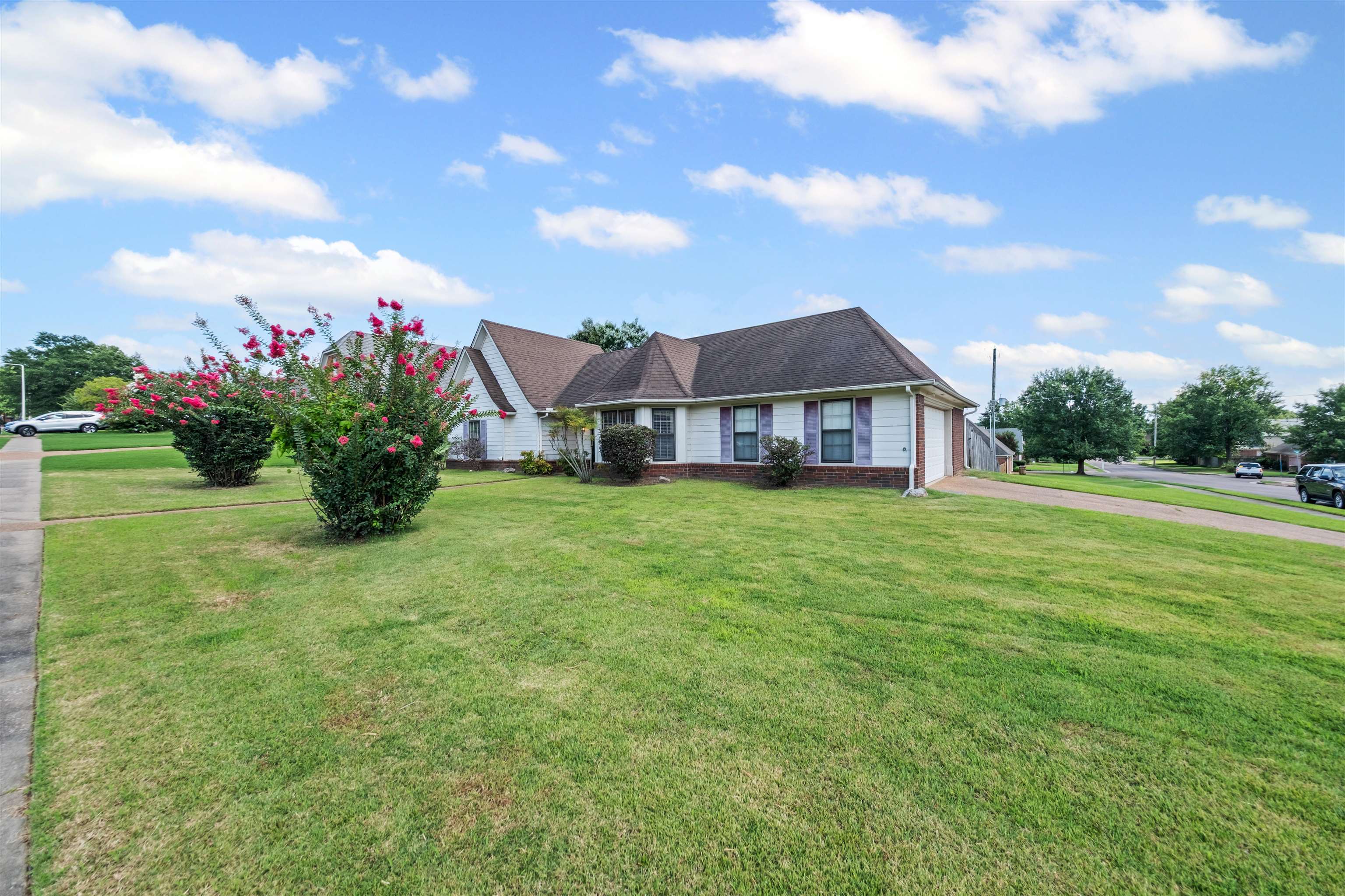 8645 Bazemore Road Memphis, TN 38018 - Photo 28 of 28 View of front of house with brick siding, driveway, a front yard, and a garage