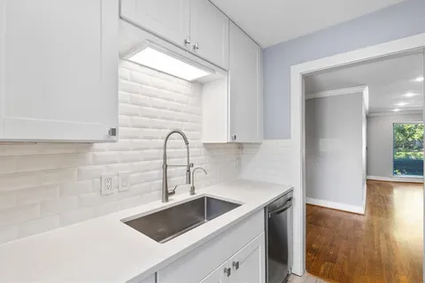 a bedroom with a bed and a potted plant