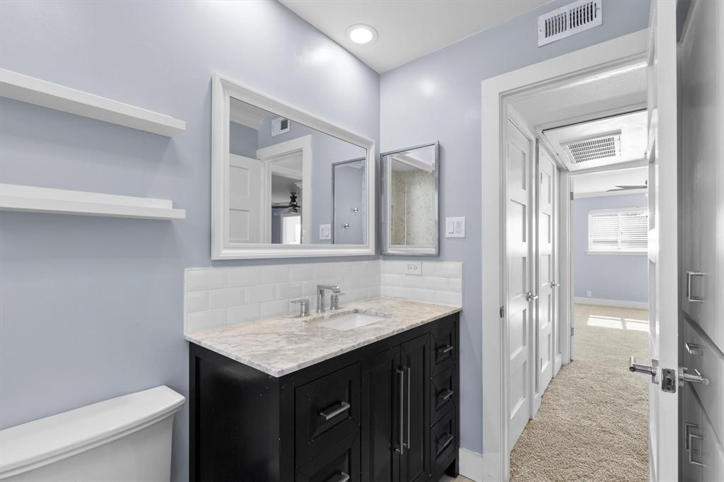 3012 Mahanna Springs Drive, Unit A Dallas, TX 75235 - Photo 18 of 29 a bathroom with a sink a toilet and shower